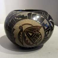 Black jar with a sgraffito avanyu and geometric design