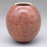 A red-on-white jar decorated with a sgraffito geometric design