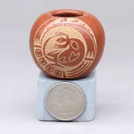 A miniature red seed pot with a sgraffito lizard and geometric design
 by Mae Tapia of Santa Clara