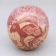 A red seed pot decorated with a sgraffito Mimbres-style rabbit and geometric design