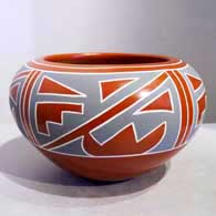 Four-panel geometric design on a polychrome red bowl
