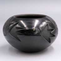 Black jar carved with a geometric design