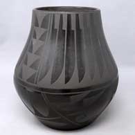 Black on black jar with jeather and geometric design, by Carmelita Dunlap of San Ildefonso Pueblo