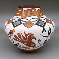 A polychrome jar decorated with a parrot, branch, bery, rainbow and geometric design