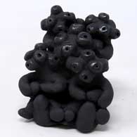 Black mudhead figure with 4 children