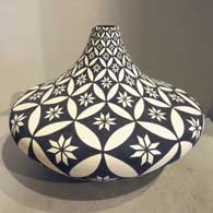 A black and white jar with geometric design