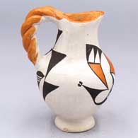 A polychrome pitcher with a twisted handle and geometric design