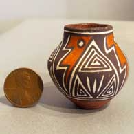 A miniature polychrome jar with a geometric design