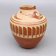 A polished red jar with an organic opening and a sgraffito avanyu, feather ring, and kiva step geometric design