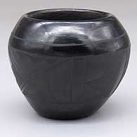 A black-on-black bowl with a band of geometric design around the exterior