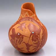 Red jar with an organic opening, inlaid stones and a sgraffito hummingbird, flower, branch and geometric design