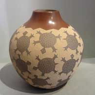 Sgraffito turtle design on a brown jar