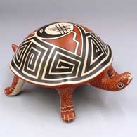 Polychrome turtle figure with a geometric design on its shell