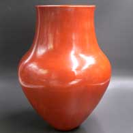 A plain, polished red jar