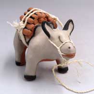 A burro figure with a load of firewood on its back