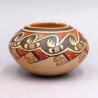 A small polychrome jar with a band of feather, bat wing and geometric design