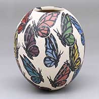 A polychrome jar decorated with a sgraffito-and-painted butterly and geometric design