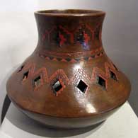 Dineh design on an orange pot