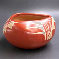 A polychrome bowl with a triangular opening and a geometric design