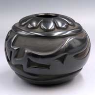 Black jar carved with an avanyu and geometric design