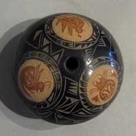 Sienna spots and sgraffito designs on a black seedpot