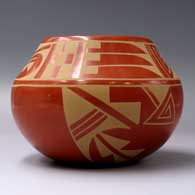 A buff-on-red jar with a 4-panel geometric design