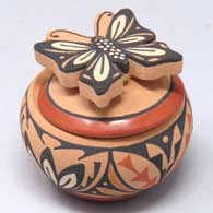 Jar with a geometric design and a butterfly handle, by Mary Louise Eteeyan