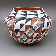 A polychrome jar with a six-panel geometric design