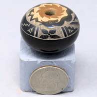 Miniature black seed pot with sienna rim and sgraffito avanyu and geometric design
