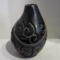 Geometric design carved into a black on black jar, by Nathan Youngblood