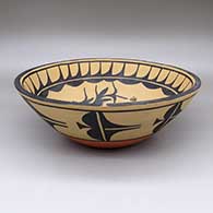 A large polychrome bowl with a bird, flower and geometric design