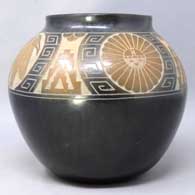 Black jar with sienna spots and sgraffito wildlife and geometric designs