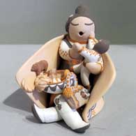 One child on a grandmother storyteller figure