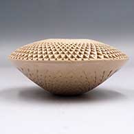 A flying saucer jar with a toled geometric design all over