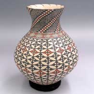 A polychrome jar with a recurved neck and decorated with bands of geometric design