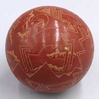 A red seed pot with a sgraffito pronghorn antelope and geometric design