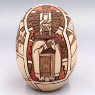 A polychrome seed pot lightly carved and painted with a Pueblo dancer, katsina and geometric design