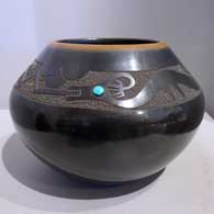 Black jar with a sienna rim, sgraffito avanyu and geometric design and an inlaid stone