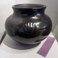 Bear paw imprints in a polished black jar