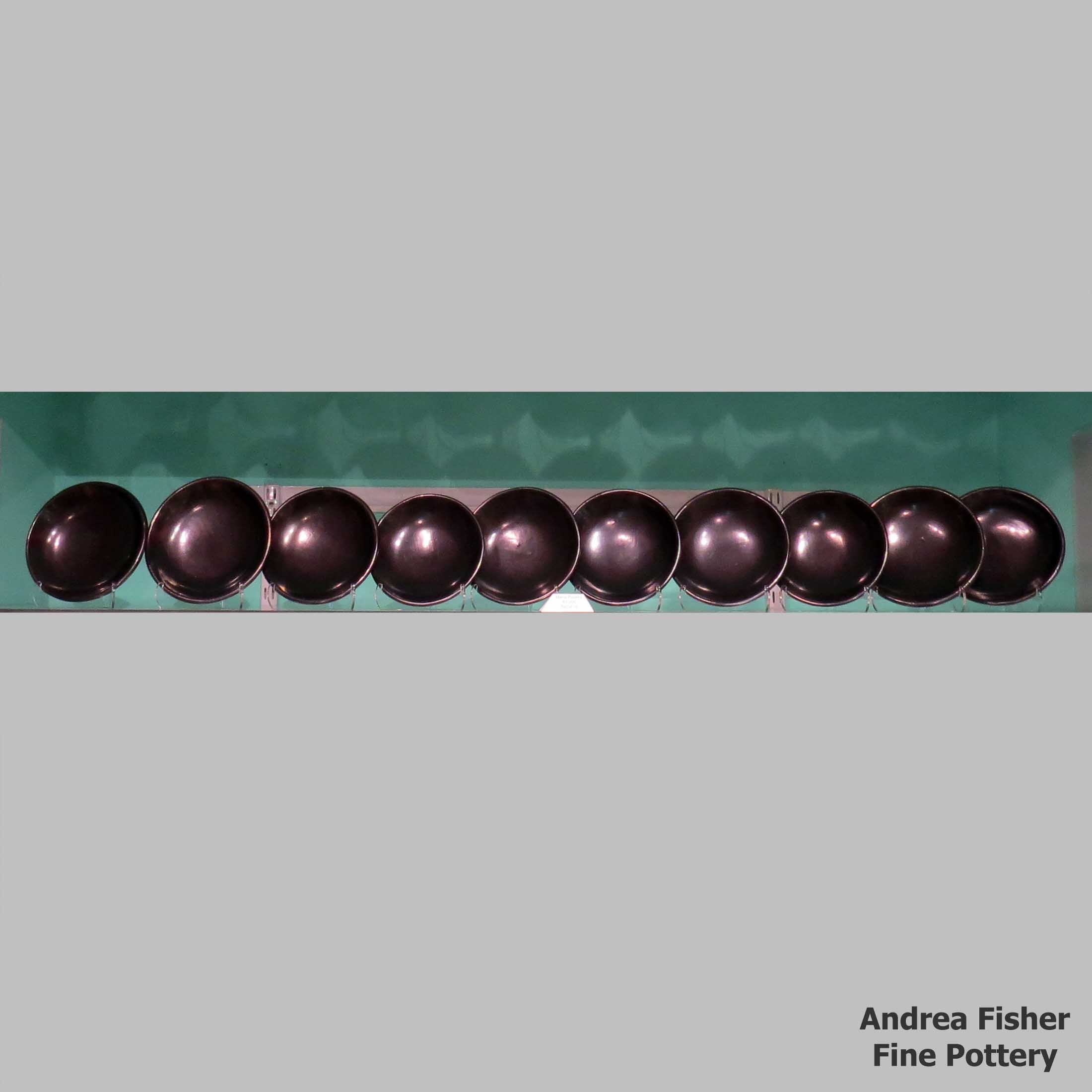 Click or tap to see a larger view Set of 10 plain black plates made by Maria Martinez of San Ildefonso