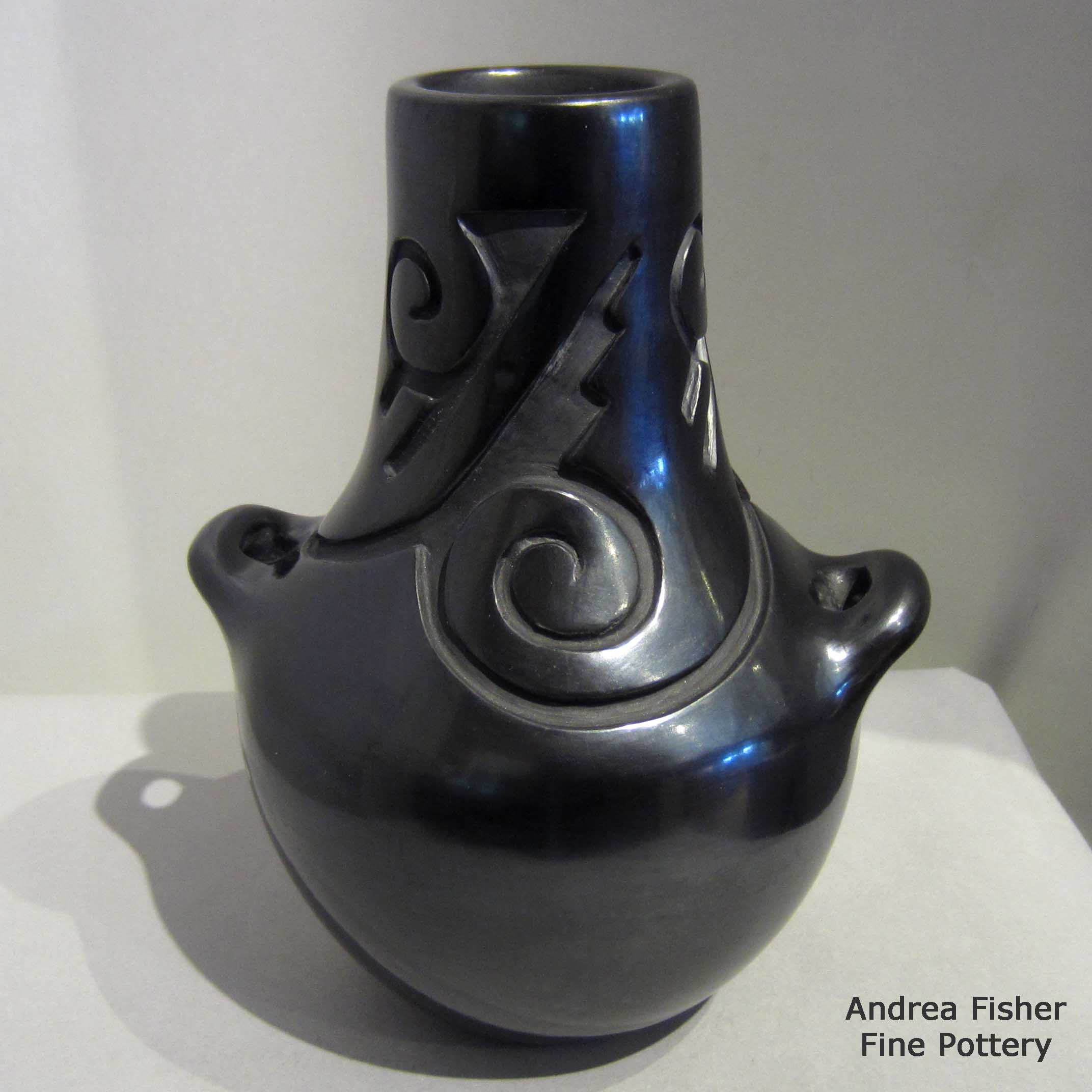 Virginia Ebelacker created this piece, Click or tap to see a larger version Tallneckblackjarwithhandlesandcarvedwithkivastep,Tularosaspiralandgeometricdesign, Click or tap to see a larger version