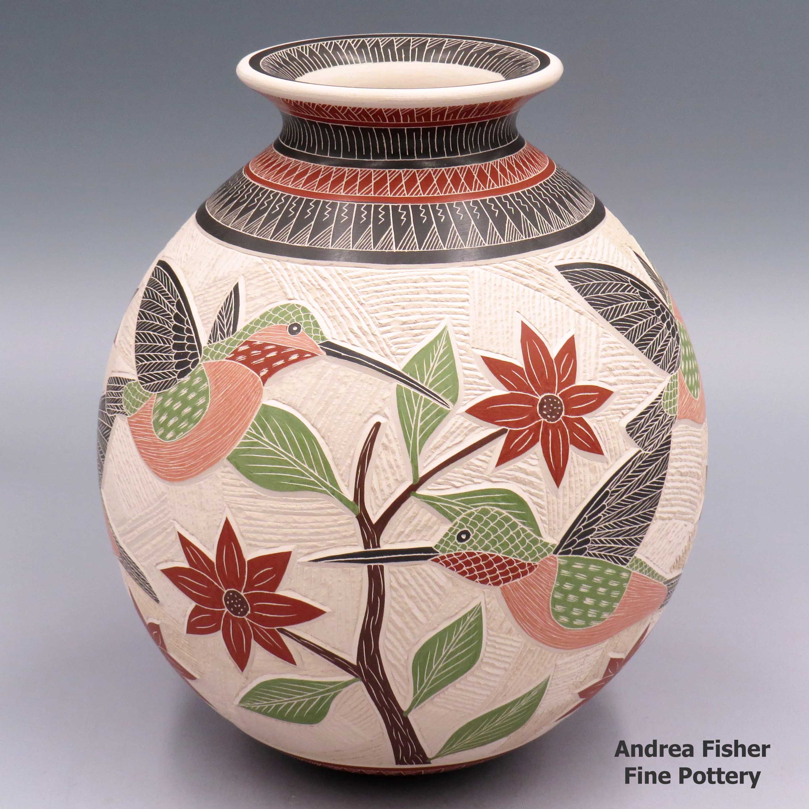 Polychrome jar with a rolled lip and a sgraffito and painted 3-panel hummingbird, flower, branch, leaf and geometric design made by Jesus Olivas of Mata Ortiz and Casas Grandes