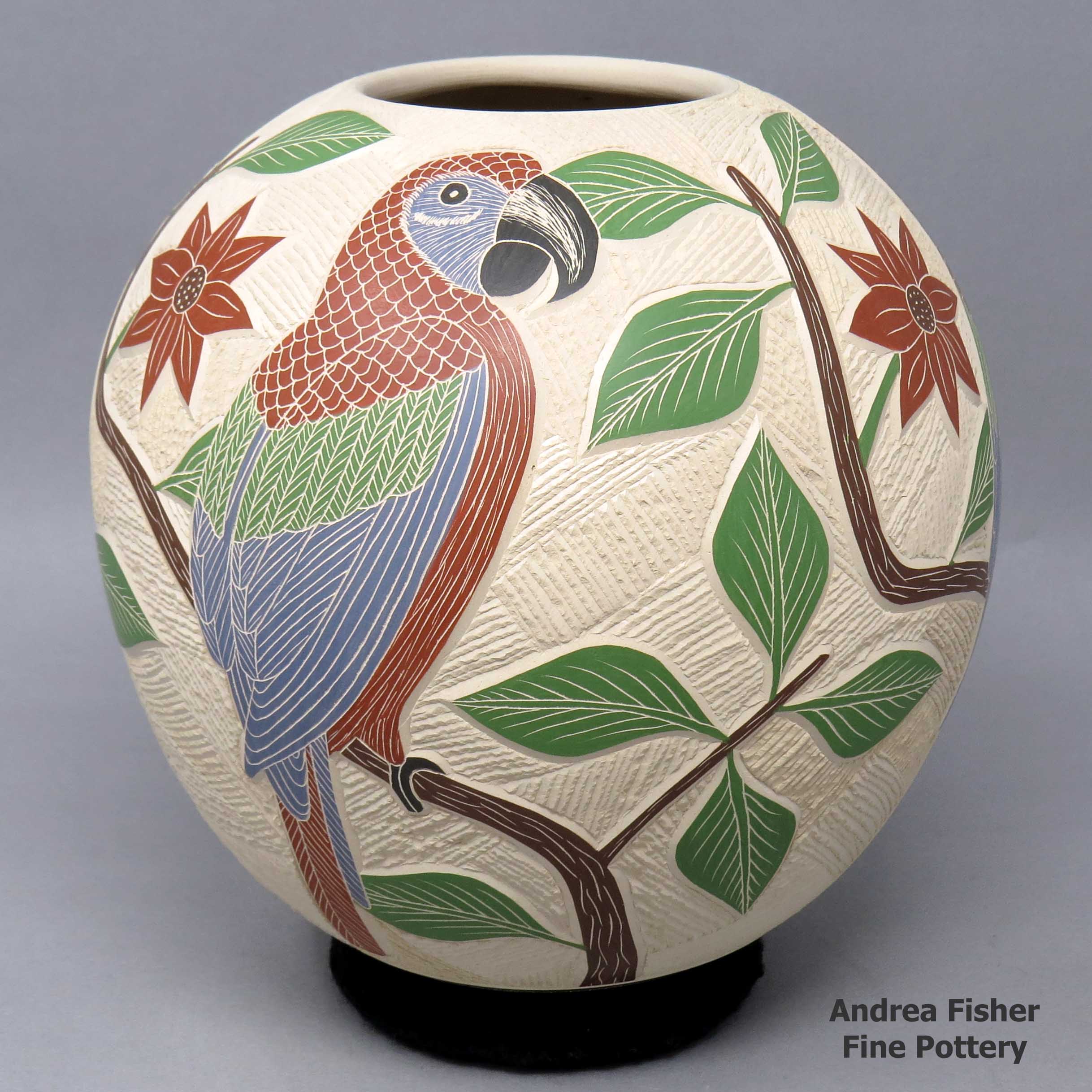 Click or tap to see a larger view Polychrome jar with sgraffito and painted bird, branch and geometric design
made by Jesus Olivas of Mata Ortiz and Casas Grandes