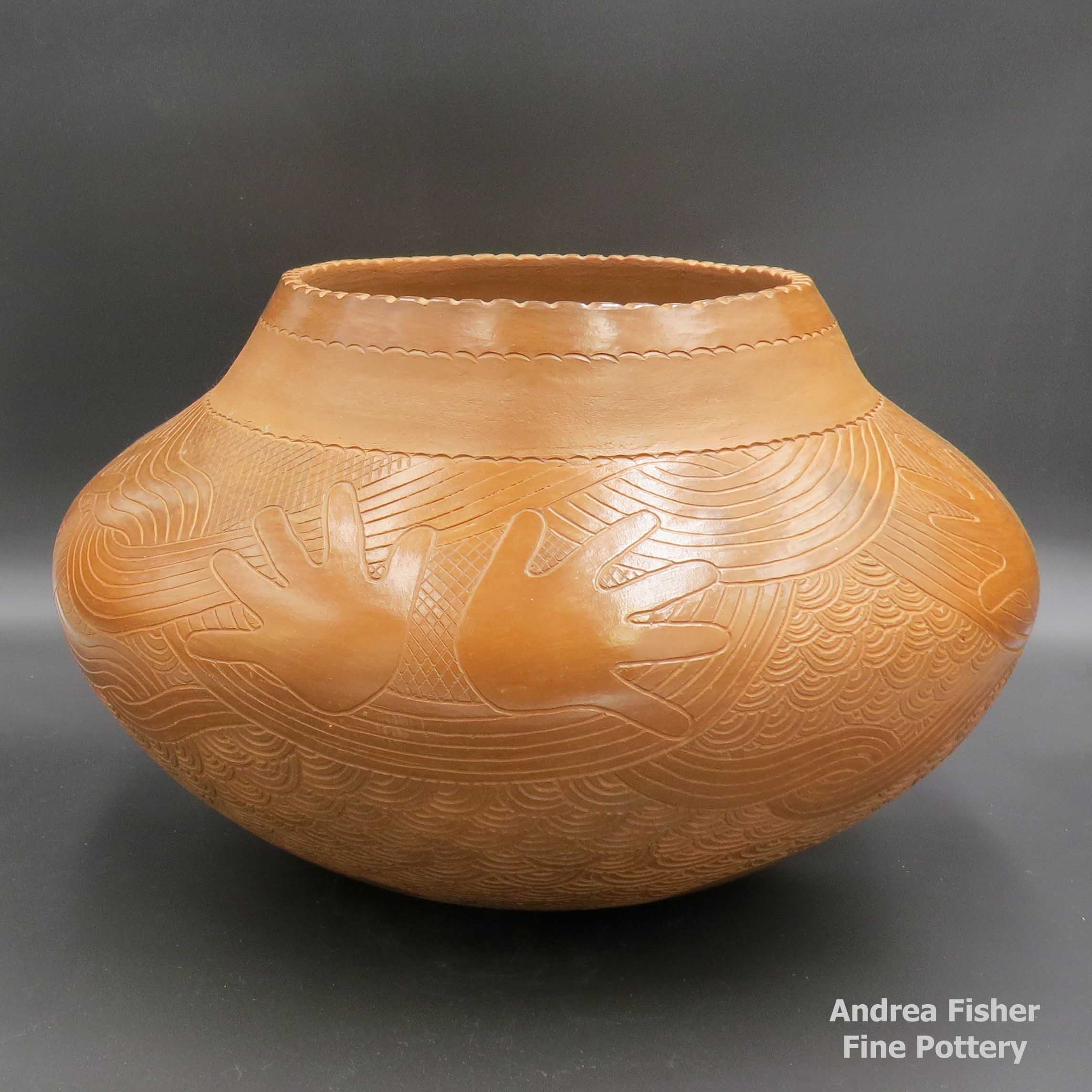 Click or tap to see a larger view Brown jar with carved hand and geometric design made by Jane Osti of NonPueblo