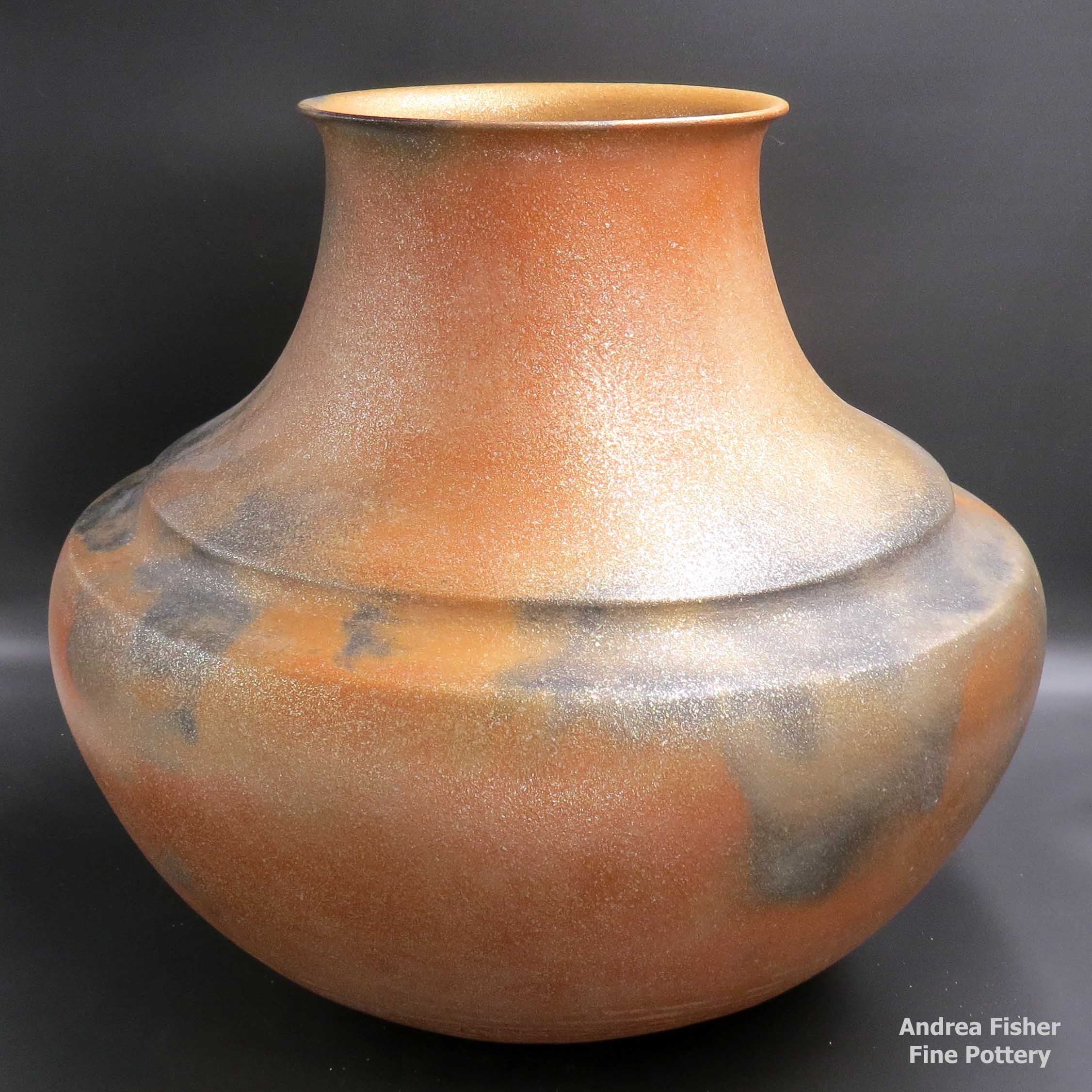 Click or tap to see a larger view Large double-shoulder golden micaceous jar with fire clouds made by Lonnie Vigil of Nambe