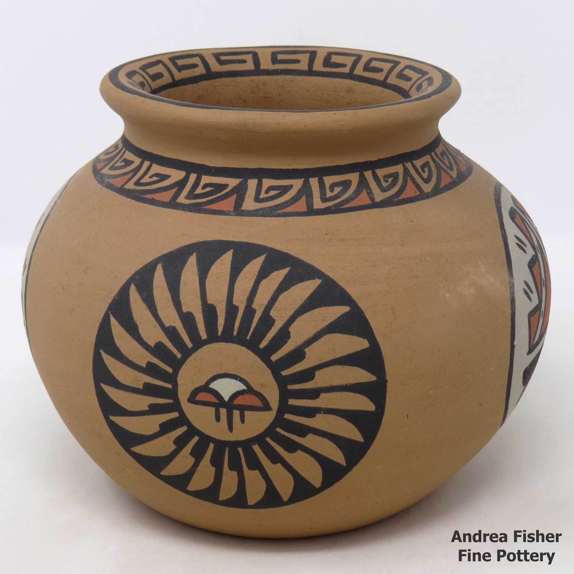 Click or tap to see a larger view Polychrome Pojoaque-style jar with medallion and geometric design
made by Minnie Vigil of Santa Clara