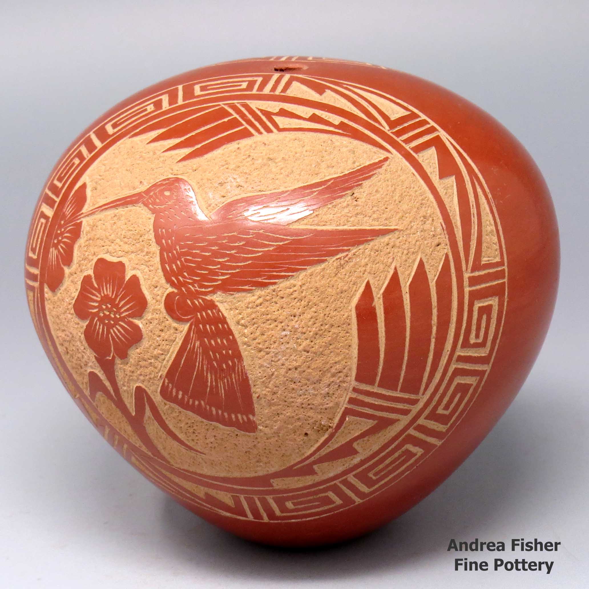 Vangie Tafoya created this piece, Click or tap to see a larger version Redseedpotwithasgraffitohummingbird-and-flowermedallionandabutterfly-and-flowermedallionandmoregeometricdesign, Click or tap to see a larger version