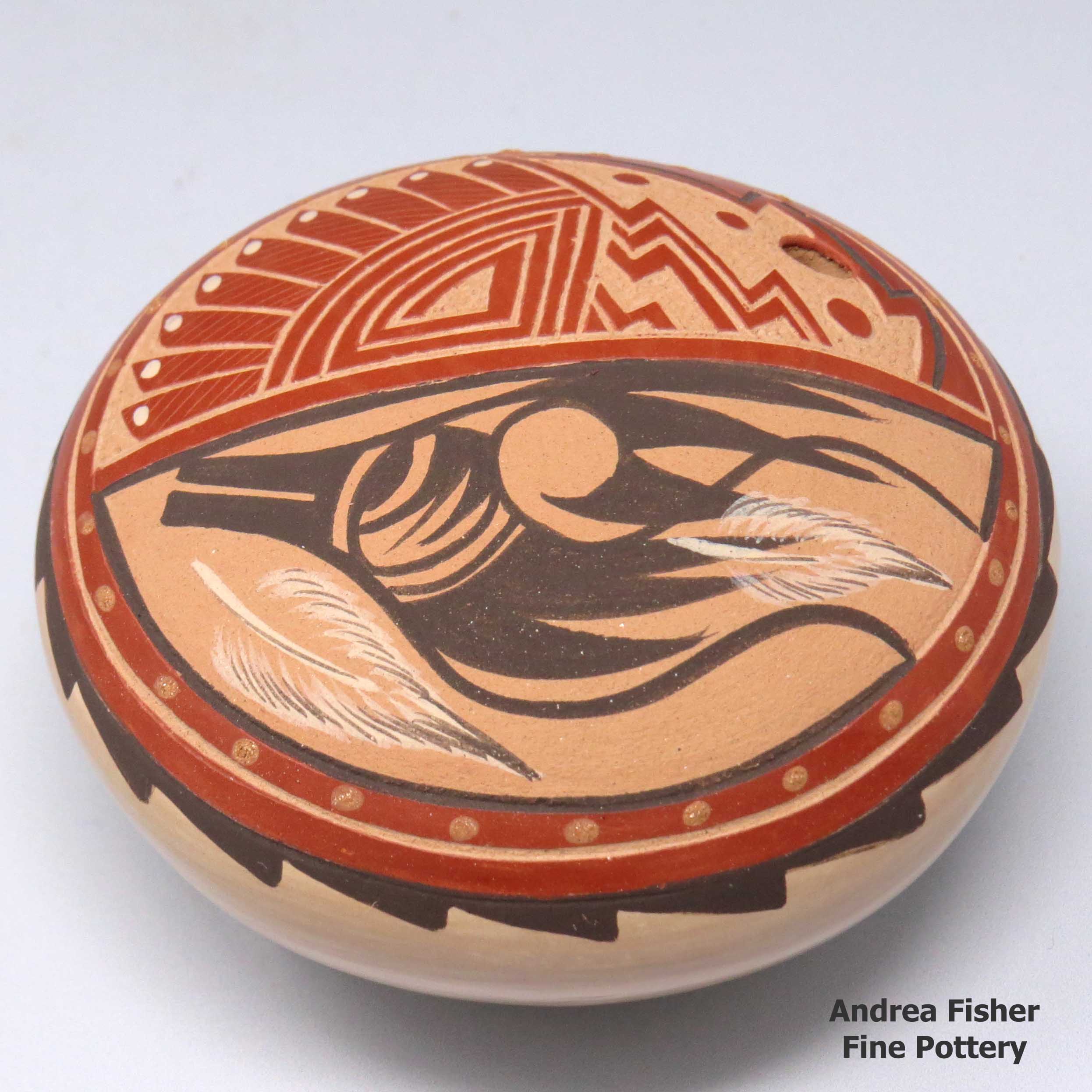 Click or tap to see a larger view Polychrome seed pot with a sgraffito and painted avanyu, feather and geometric design made by Helen Tafoya Henderson of Jemez
