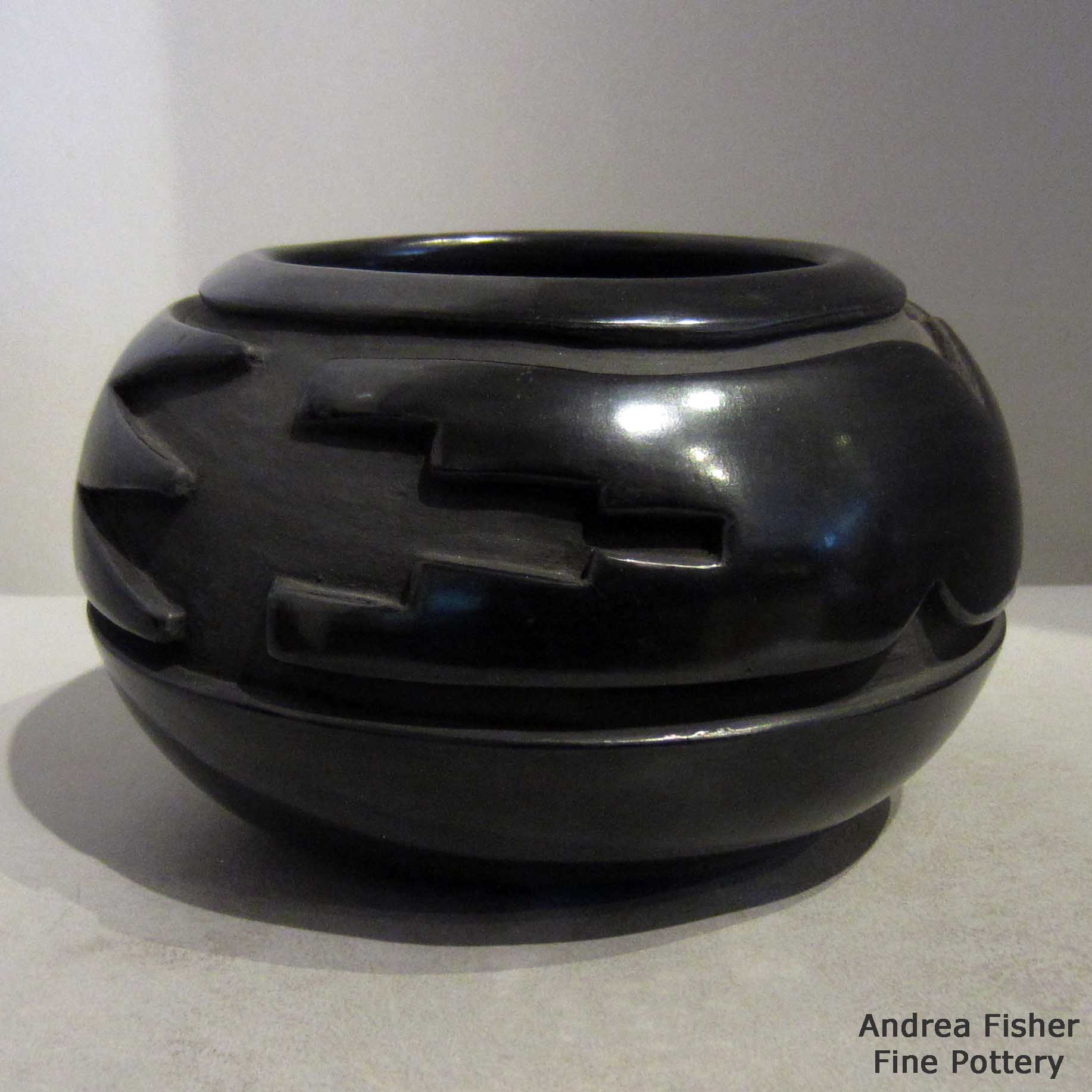 Click or tap to see a larger view Black jar carved with stylized avanyu design made by Teresita Naranjo of Santa Clara