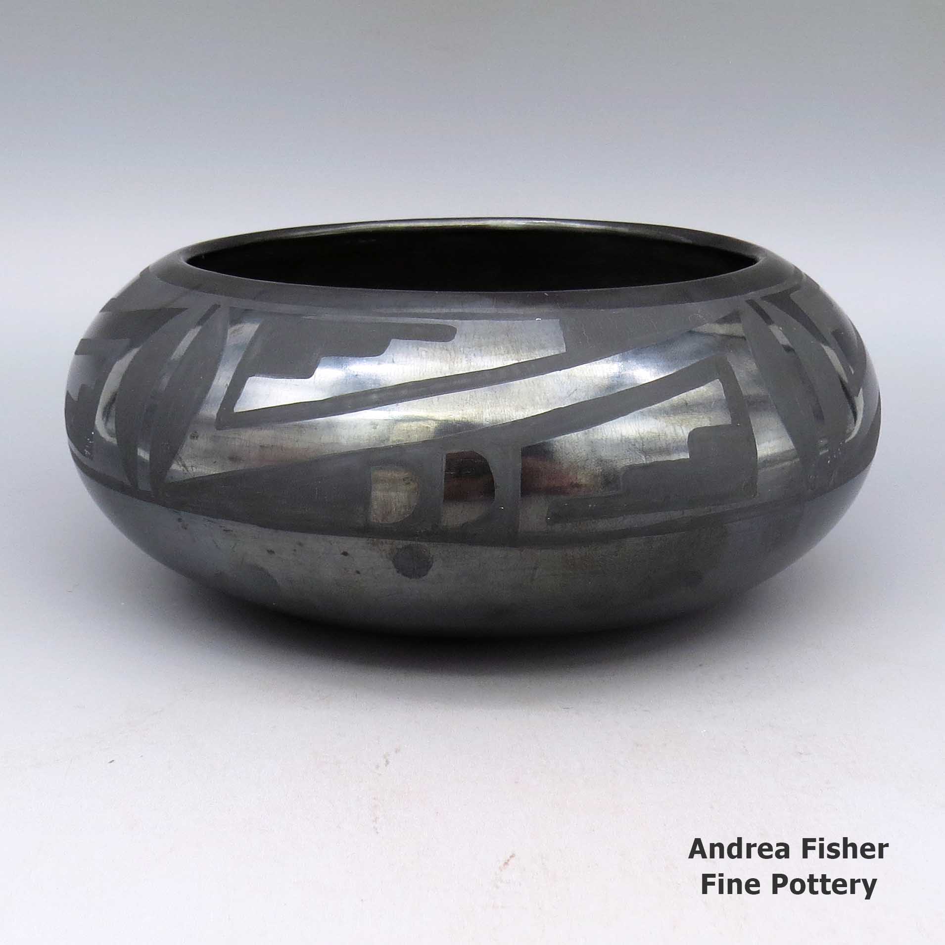 Black-on-black bowl with a geometric design made by Maria Martinez of San Ildefonso